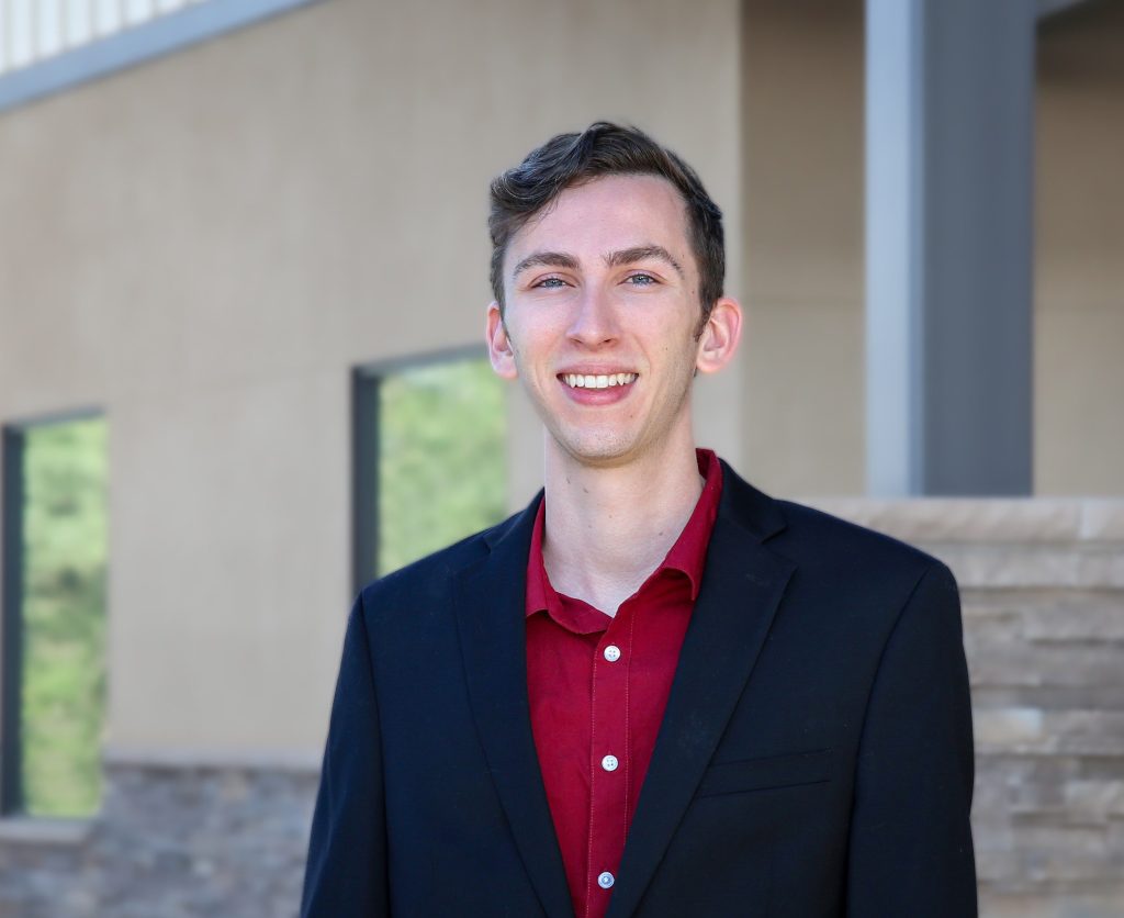 Head Shot of Gentles in a red button up shirt