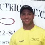 Man wearing a yellow shirt and black cap with 'Jasen' name tag